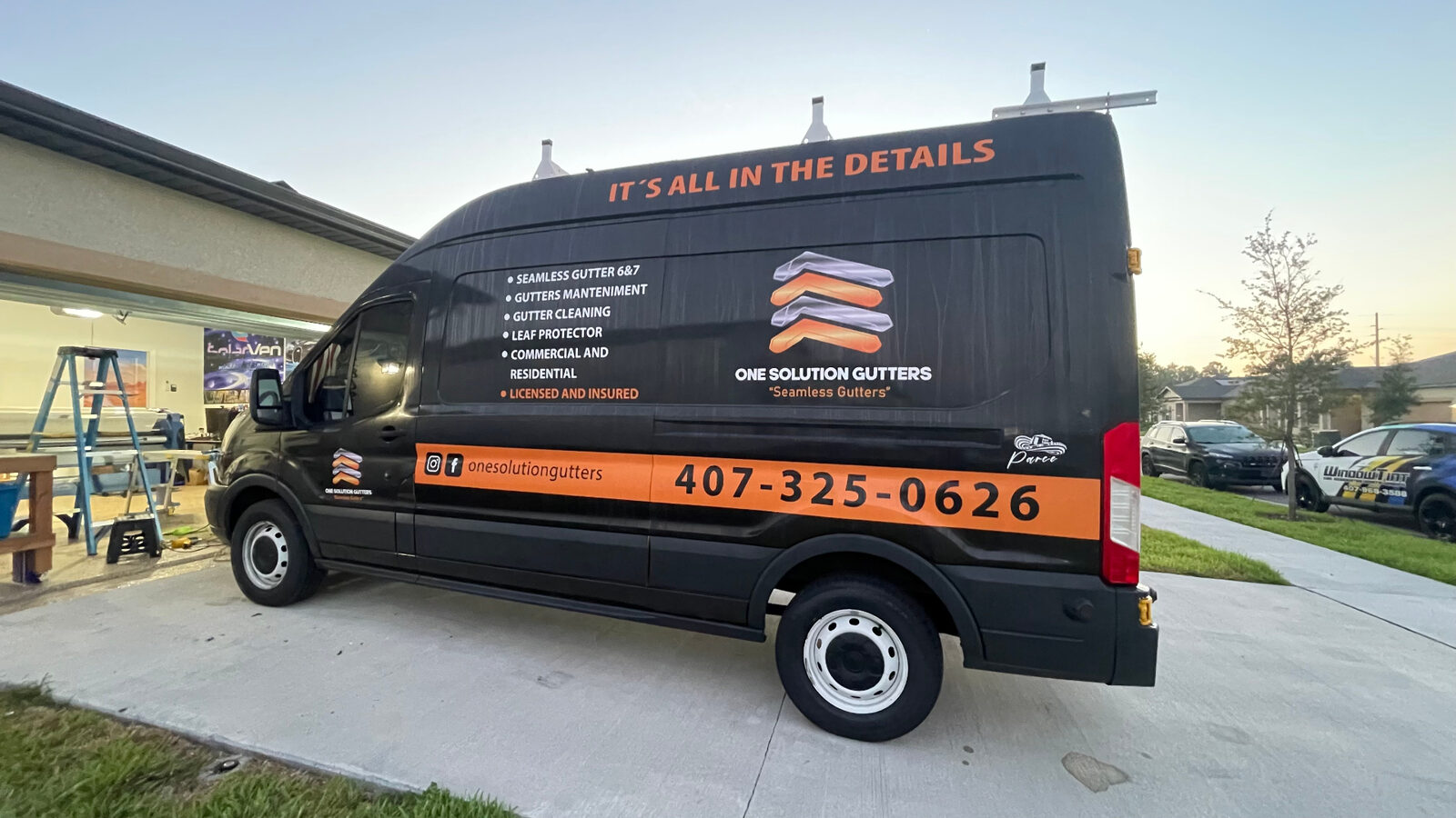 One Solution Gutters black commercial van wrap side view